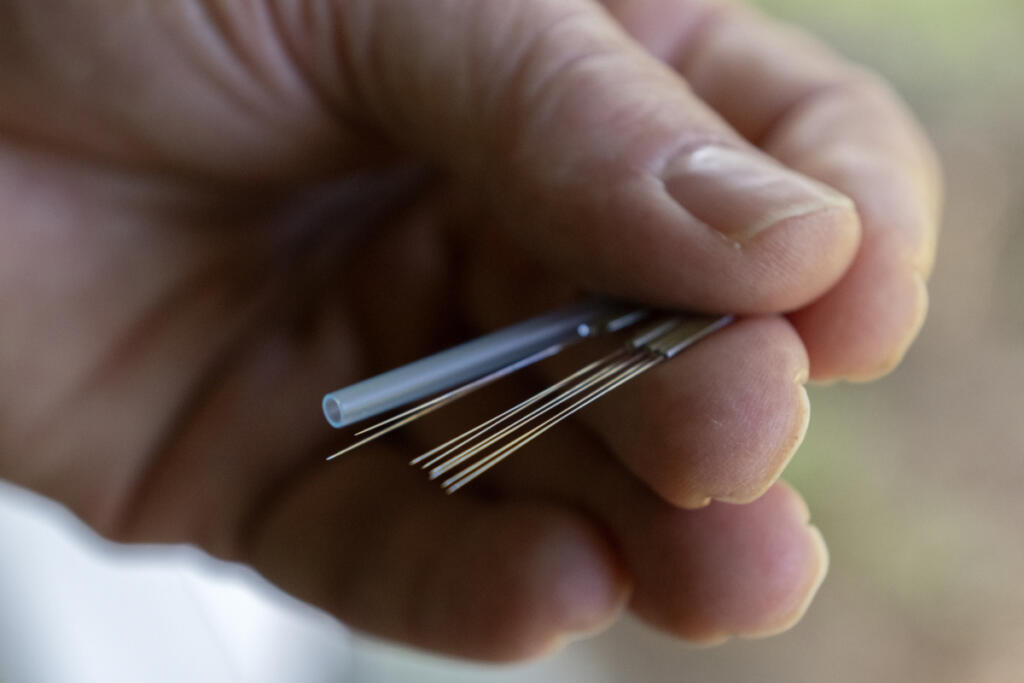 Michael Prevec, an acupuncturist at Ripple Wellness in Washougal, holds acupuncture needles in a treatment room. (Amanda Cowan/The Columbian)