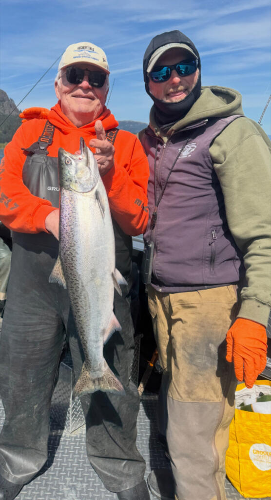 Fishing guide Bill Monroe, right, and a client display a fine Wind River spring chinook. These upriver salmon are one of the most sought-after strains of Columbia River springers. (Photo courtesy Bill Monroe Outdoors)
