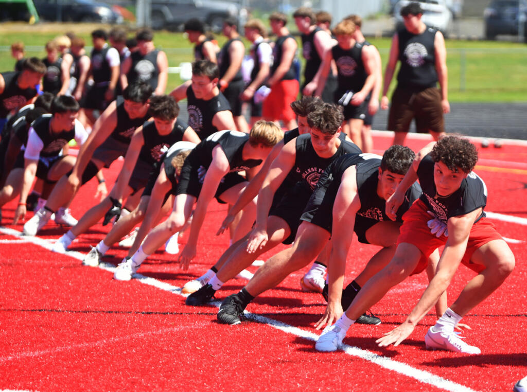High school football participants do warmup drills at the Washington State Football Coaches Association College Showcase on Sunday at Camas HS. (Photos by Micah Rice/The Columbian)