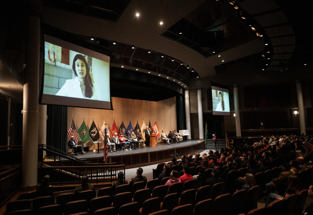 Audience members watch a video message from Rep. Marie Gluesenkamp Perez, D-Skamania, on April 22 during an event for future military service members at Skyview High School. (Taylor Balkom/The Columbian)