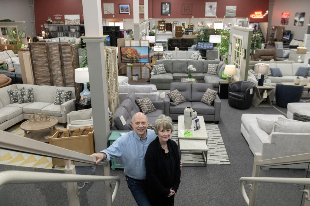 Dave and Molly Fletcher of One Stop Home Furnishings take a break in their Camas showroom on April 20.