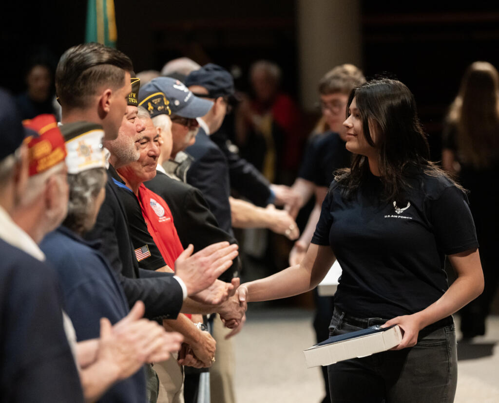 Air Force recruit Kylie Ericcsen shakes hands April 22 during an event for future military service members at Skyview High School. (Taylor Balkom/The Columbian)
