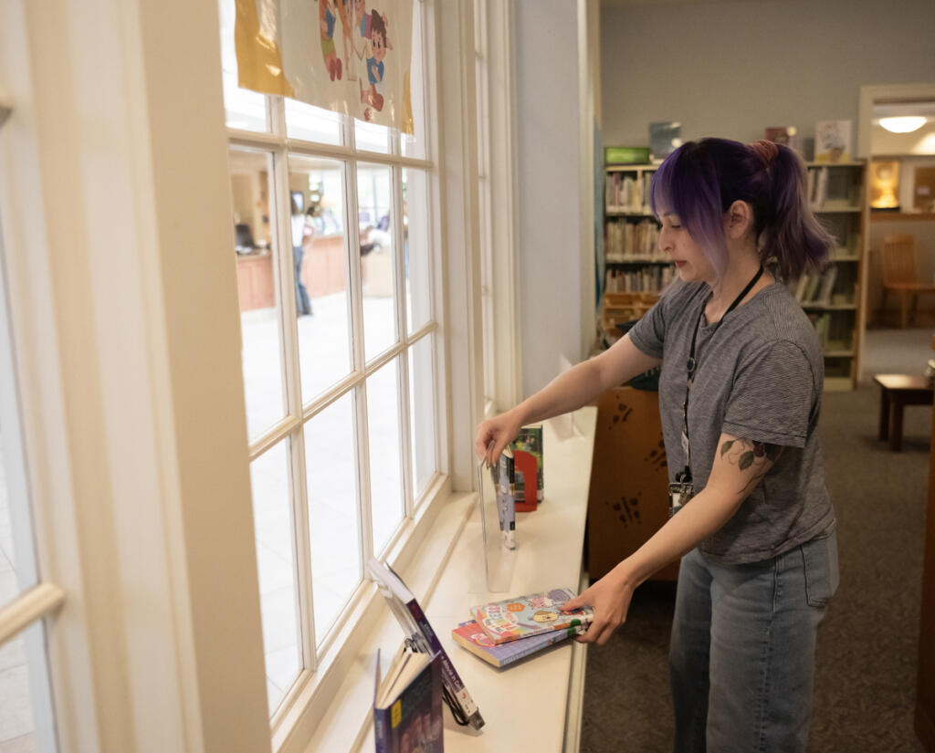 Library associate
Maria Martin sets books up in the Kid Librarian display April 27 at the Camas Public Library. The library runs a Kid Librarian program that invites area kids to pick their favorite books to put in a display for a week. (Taylor Balkom/The Columbian)