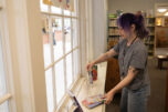Library associate
Maria Martin sets books up in the Kid Librarian display April 27 at the Camas Public Library. The library runs a Kid Librarian program that invites area kids to pick their favorite books to put in a display for a week. (Taylor Balkom/The Columbian)