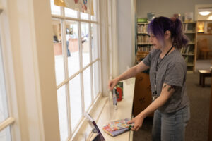 Library associate
Maria Martin sets books up in the Kid Librarian display April 27 at the Camas Public Library. The library runs a Kid Librarian program that invites area kids to pick their favorite books to put in a display for a week. (Taylor Balkom/The Columbian)