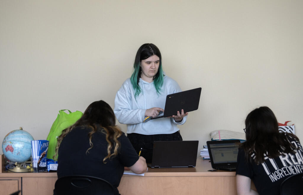 PAX Learning Center tutor and GED coordinator Mya Smirke, center, works with students during a class at Clark College&rsquo;s Columbia Tech Center campus on Monday afternoon. (Amanda Cowan/The Columbian)