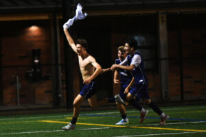 Lucas Angelback of Skyview waves his jersey in the air as his celebrates a goal with teammates Leif Evenson, center, and Ismael Bravo during a 4A Greater St. Helens League boys soccer match against Camas at Kiggins Bowl on Friday. (Tim Martinez/The Columbian)