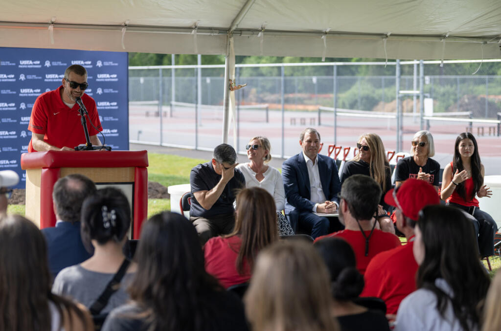 Camas Athletic Director Stephen Baranowski, left, talks to a crowd Tuesday during a groundbreaking for the Camas Tennis Center at Camas High School. (Taylor Balkom/The Columbian)
