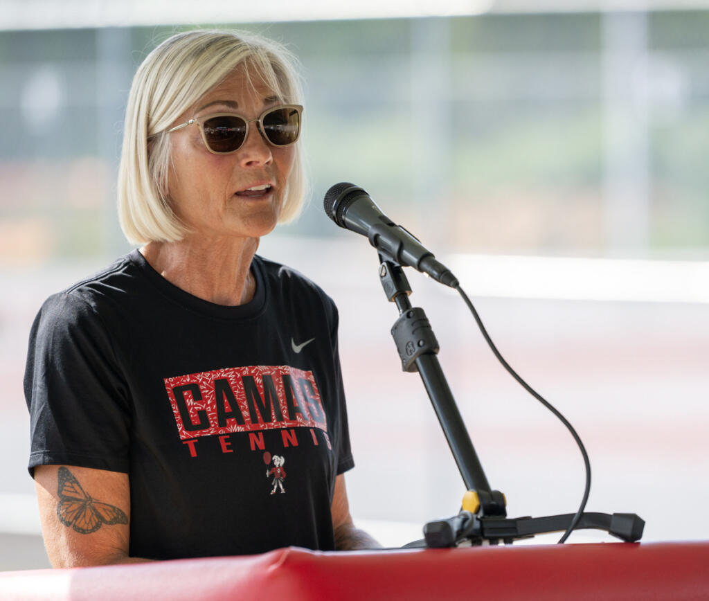 Tennis coach Annie Sumpter talks Tuesday during a groundbreaking for the Camas Tennis Center at Camas High School. (Taylor Balkom/The Columbian)