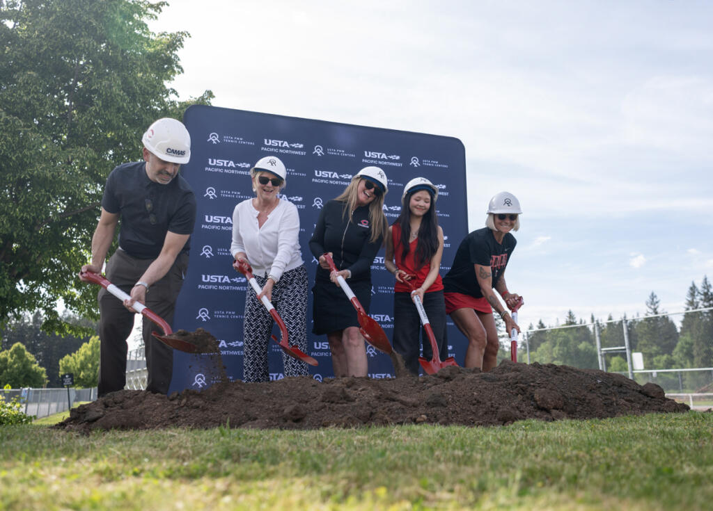 Dignitaries shovel dirt as part of a ceremonial groundbreaking May 12 during a ceremony for the Camas Tennis Center at Camas High School. (Taylor Balkom/The Columbian)
