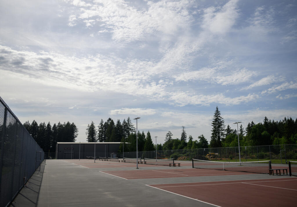 Partly cloudy skies hang above the Camas High School tennis courts Tuesday during a groundbreaking for the Camas Tennis Center at Camas High School. (Taylor Balkom/The Columbian)