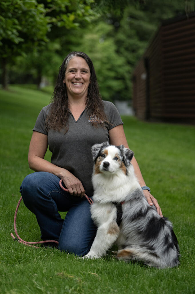 Katie High, owner and lead trainer at High Expectations Dog Training, takes a break with four-legged client Raine, 2, in Camas on a recent morning. (Amanda Cowan/The Columbian)