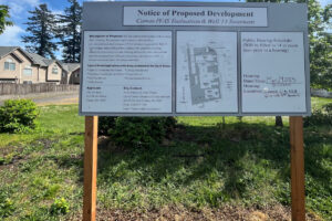 A notice of proposed development sign stands on the city of Camas&rsquo; Well 13 property off Southeast Cramer Lane in May 2025. (Kelly Moyer/The Columbian files)