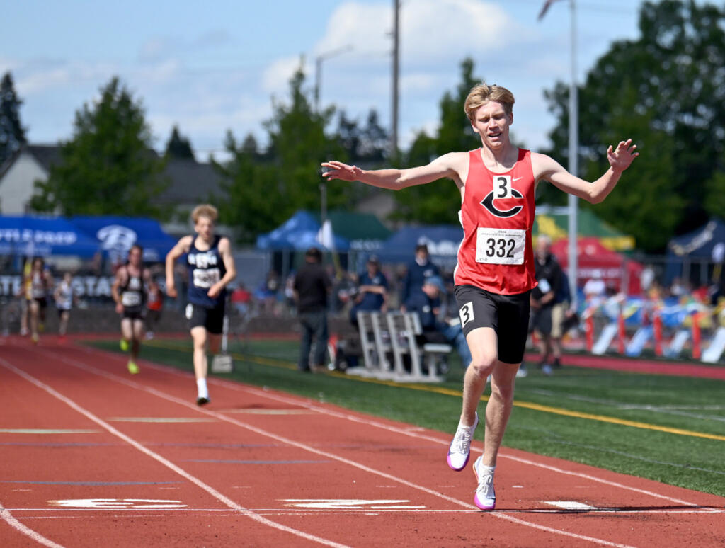 Camas senior Cohen Butler, right, celebrates after winning the 4A boys 3200 meter race Saturday during WIAA State Track and Field Meet at Mount Tahoma High School in Tacoma. Butler set a state meet record with a time of 8:43.77. (Taylor Balkom/The Columbian)