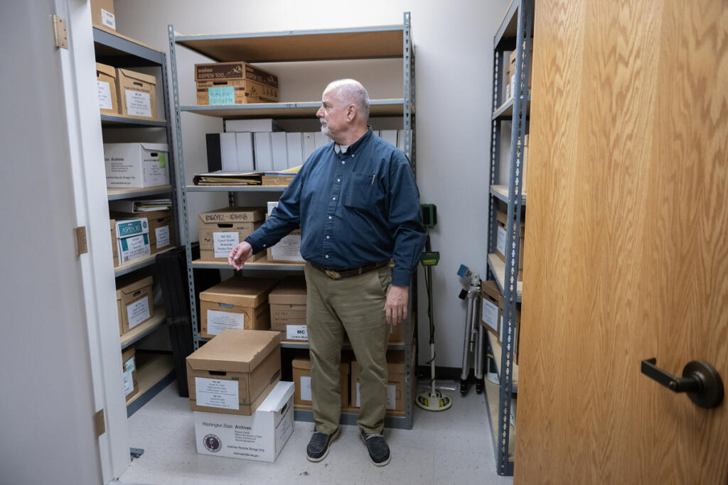 Investigator Michael Ramon looks over files at the Clark County Sheriff&rsquo;s Office Cold Case Unit office in downtown Vancouver on May 14. (Amanda Cowan/The Columbian)