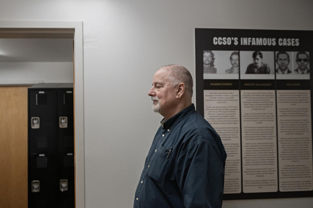 Volunteer investigator Michael Ramon walks through the hallway at the Clark County Sheriff&rsquo;s Office Cold Case Unit offices in downtown Vancouver on May 14. Ramon is retired from the U.S. Marshals Service.