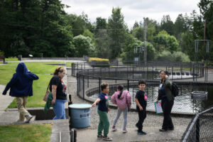 Environmental educator Jamie Austin, right, leads a group of Crestline Elementary first graders on a tour May 19 at the Columbia Springs Vancouver Trout Hatchery. (Taylor Balkom/The Columbian)