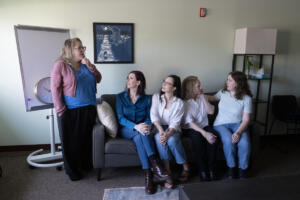 YWCA&rsquo;s Domestic Violence High Risk Team specialist Malerie Paynter, from left, chats with volunteers Kristi Hafdahl, Jade Embry, Paula Paulsen and Kirsten David at the YWCA last week. Funding for the YWCA&rsquo;s Domestic Violence High Risk Team is in jeopardy. (Photos by Amanda Cowan/The Columbian)