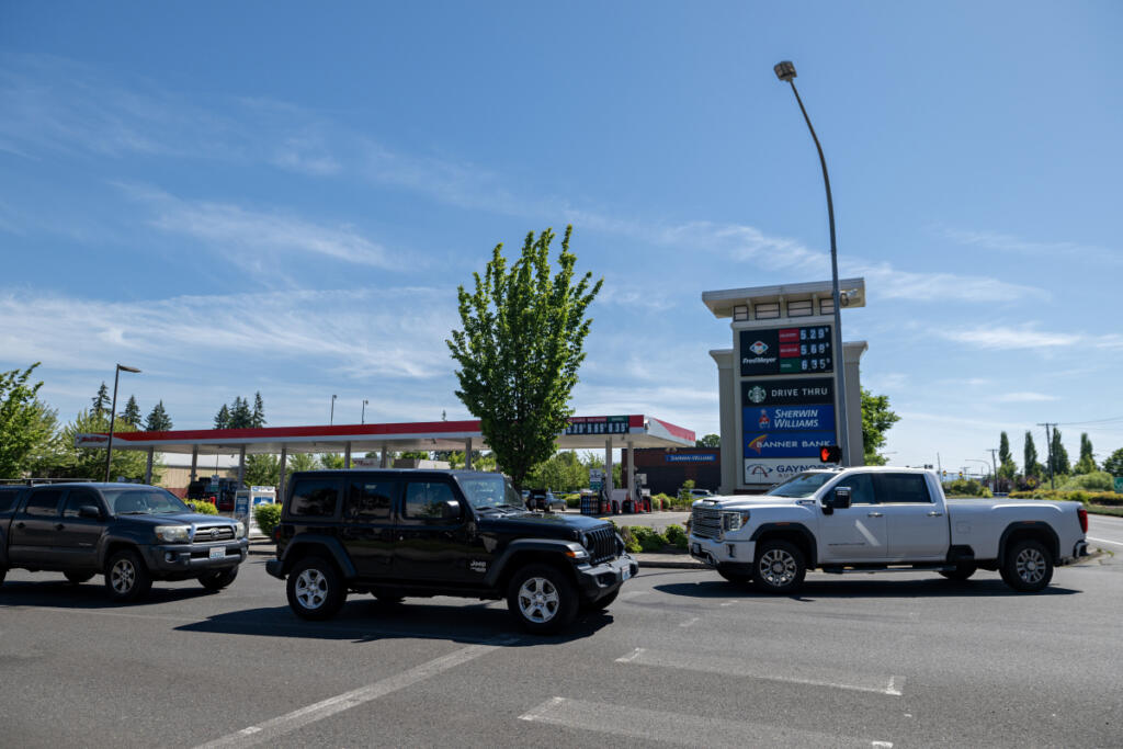 Customers stop by the gas station near the Fred Meyer in Salmon Creek to fill up their tanks Monday morning. Inflation this summer may impact local families&rsquo; plans, such as traveling, sporting events and gardening. (Amanda Cowan/The Columbian)