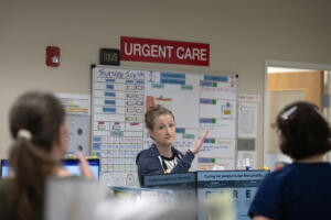 Clinical nurse lead Kim Fleshman talks with colleagues while getting the day started at Vancouver Clinic&rsquo;s Salmon Creek Urgent Care facility June 4. (Amanda Cowan/The Columbian)