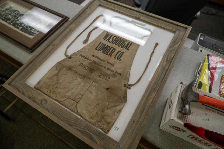 A framed apron and other memorabilia sit on a counter June 11 at Washougal Lumber Co. in Washougal.