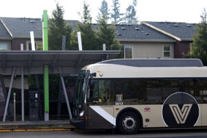 A C-Tran bus travels past apartments along Fourth Plain Boulevard on Jan. 29, 2024. (Amanda Cowan/The Columbian)