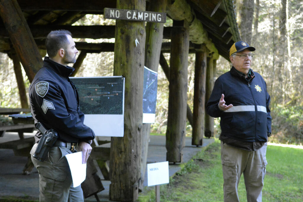 Clark County Sheriff&rsquo;s Office Sgt. Matt Volker and Cold Case Unit volunteer Doug Maas conduct a briefing April 3 before a search of the Yacolt Burn area for the remains of Jamie Grissim, who was 16 when she went missing in 1971. (Tyler Brown/The Columbian)