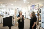 Curator Lara Blair, center, and gallery owner Kim Nickens chat May 27 next to a miniature Gallery 408 installation in Camas. Gallery 408 has been accepted into the Seattle Art Fair, which will be held in July. (Taylor Balkom/The Columbian)