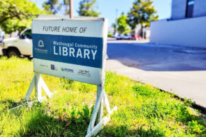A sign sits in front of the future Washougal Community Library site in downtown Washougal on May 27. (Doug Flanagan/The Columbian files)