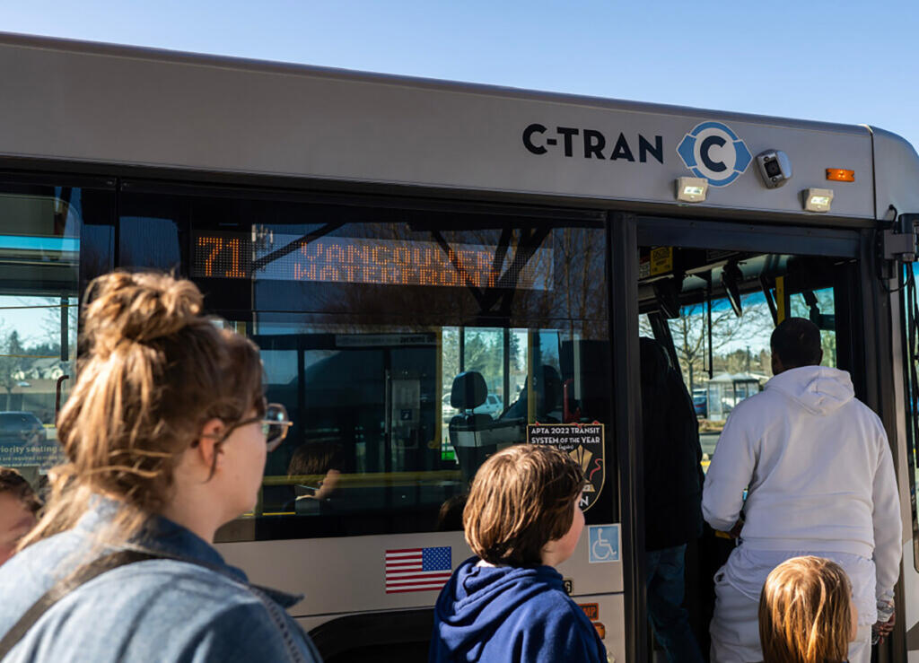 Riders board a C-Tran No. 71 bus March 26 at the 99th Street Transit Center. (Taylor Balkom/The Columbian files)