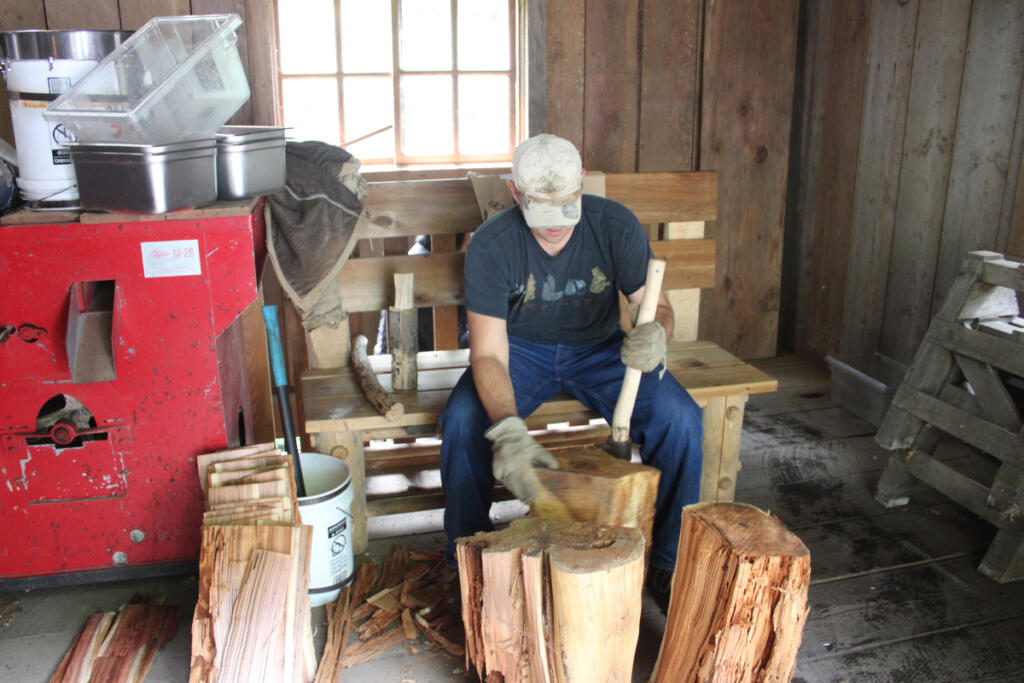 Todd Hansen of La Center chops wood Saturday afternoon inside the blacksmith shop at the Cedar Creek Grist Mill in Woodland. Hansen and his sons are part of a volunteer team that will soon repair the blacksmith shop&rsquo;s cedar shake roof. The nonprofit Friends of the Cedar Creek Grist Mill group also is fundraising to repair the 45-year-old roof on the main mill building. (Kelly Moyer/The Columbian)