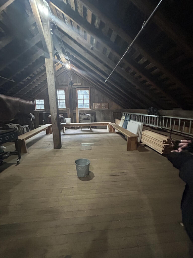 A bucket catches water from a leaky roof atop the historic Cedar Creek Grist Mill in Woodland on Saturday afternoon. The Friends of the Cedar Creek Grist Mill hopes to raise enough money, or collect enough donated materials and labor, to repair the mill&rsquo;s aging roof. (Photos by Kelly Moyer/The Columbian)