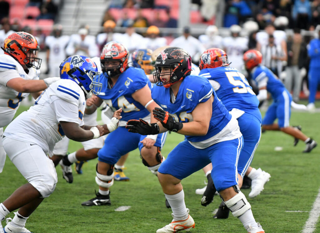 Cody Jacobus of Washougal (right), playing for Team Columbia, blocks Elijah Green of Grant, playing for Team Willamette, during the 2026 Les Schwab Bowl high school football all-star game at Lewis & Clark College in Portland on June 27. (Photos by Tim Martinez/The Columbian)