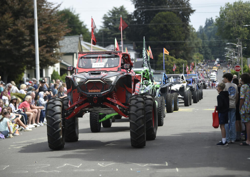 A row of utility terrain vehicles by Addiction Powersports Northwest rolls along on July 26, 2025, during the Camas Days Grand Parade in downtown Camas. (Tim Martinez/The Columbian)