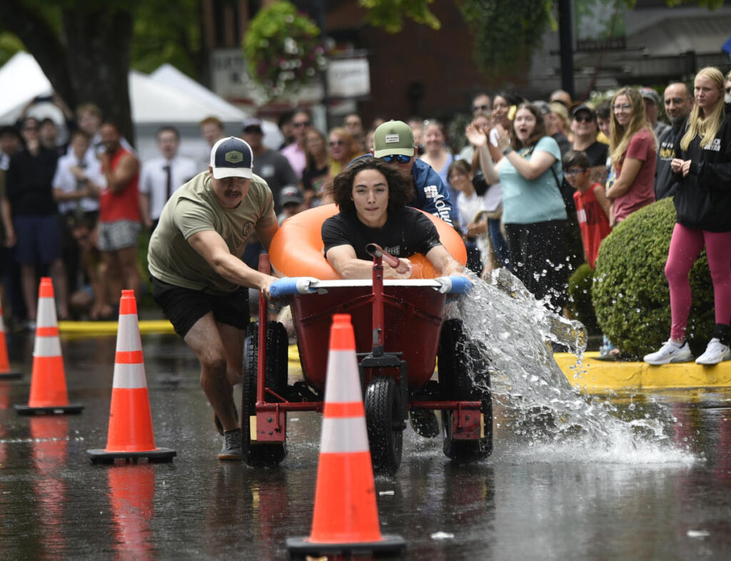 Members of the Utterly Unstoppable Lactose Legends sprint to victory in the Bathtub Races during Camas Days in downtown Camas on July 26, 2025. The annual festival will mark its 50th anniversary this year. The two-day event attracts roughly 15,000 people. (Photos by Tim Martinez/The Columbian files)