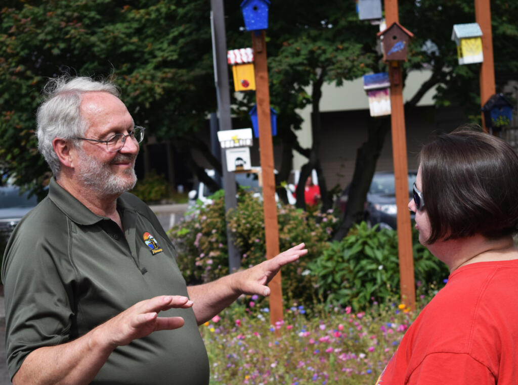 Then-Washougal City Councilor Paul Greenlee chats with Dani Allen, Jemtegaard Middle School art teacher, during a June 23, 2018, artists reception for the 11 middle school students who created designs on birdhouses hung outside Washougal City Hall. (Columbian file photo)