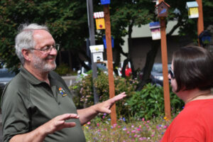 Then-Washougal City Councilor Paul Greenlee chats with Dani Allen, Jemtegaard Middle School art teacher, during a June 23, 2018, artists reception for the 11 middle school students who created designs on birdhouses hung outside Washougal City Hall. (Columbian file photo)