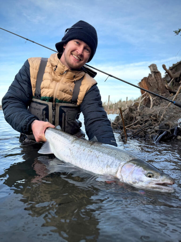 Trevor Torppa, the owner of Chrome City Guide Service, with a fine summer steelhead taken in a local tributary. Torppa offers guided fishing trips down local rivers, and he guides in Alaska as well. (Photo courtesy of Chrome City Guide Service)