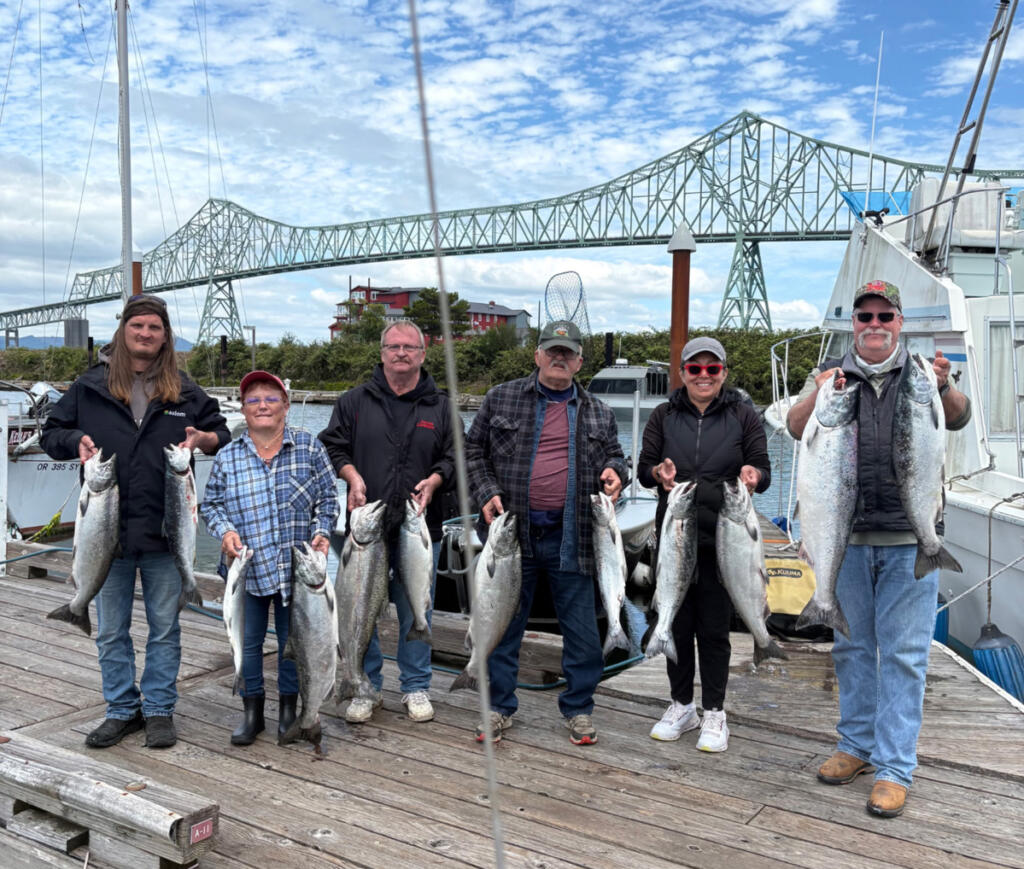 Smiles all around as anglers show off a boat limit of coho and chinook salmon taken in the Buoy 10 fishery while fishing with Jack Glass of Team Hookup Guide Service. (Photos courtesy of Team Hookup)