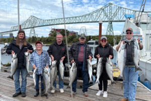 Smiles all around as anglers show off a boat limit of coho and chinook salmon taken in the Buoy 10 fishery while fishing with Jack Glass of Team Hookup Guide Service. (Photos courtesy of Team Hookup)