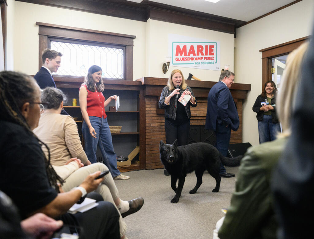 U.S. Rep. Marie Gluesenkamp Perez, D-Skamania, second from left, laughs as she is introduced by Camas Mayor Steve Hogan and Vancouver Mayor Anne McEnerny-Ogle on May 17 during a campaign volunteer event in Vancouver. Perez&rsquo;s dog, Uma Furman, steals the show. (Taylor Balkom/The Columbian)