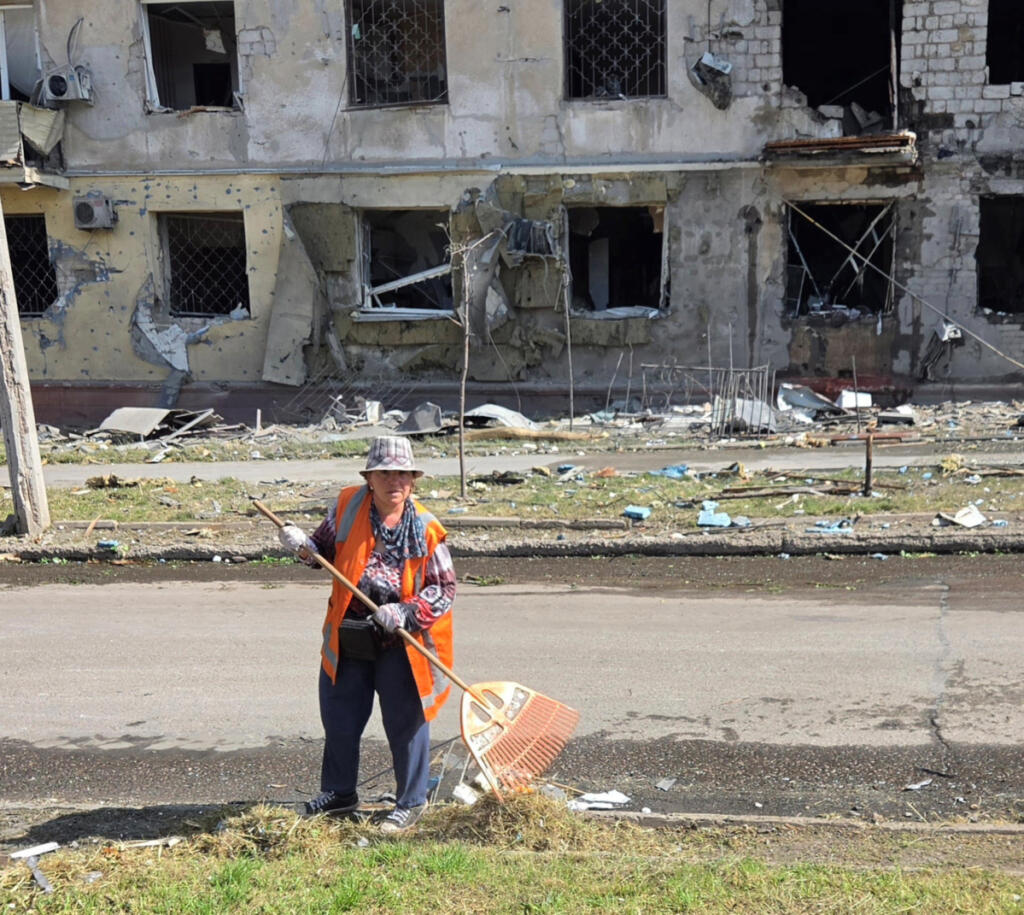 Irina, a city worker in Kramatorsk, Ukraine, sweeps the street after a Russian bombardment. &ldquo;With each sweep I am removing the enemy from my city,&rdquo; she told volunteer chaplain Mikhail Pavenko, who was visiting from Vancouver in May. (Contributed by Mikhail Pavenko)
