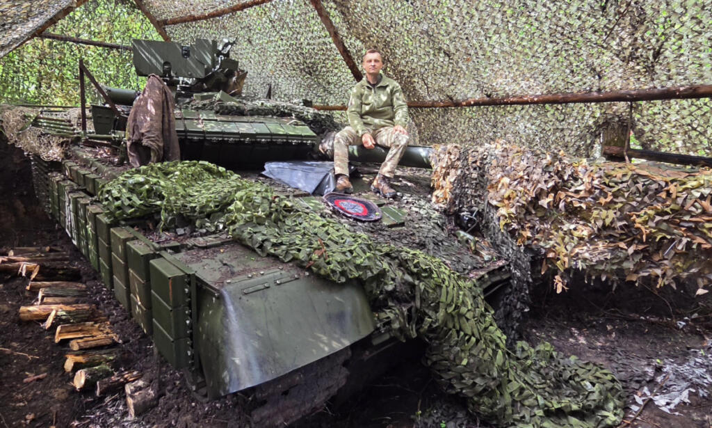 Mikhail Pavenko of Vancouver poses atop a T-72 tank with Ukraine&rsquo;s 28th Separate Mechanized Brigade. The tank is surrounded by anti-drone netting. (Contributed by Mikhail Pavenko)