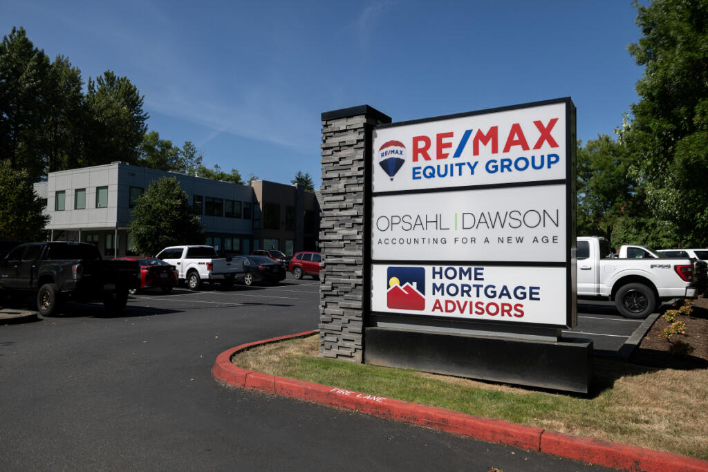 A sign is seen for Opsahl Dawson outside the building Monday morning. (Amanda Cowan/The Columbian)
