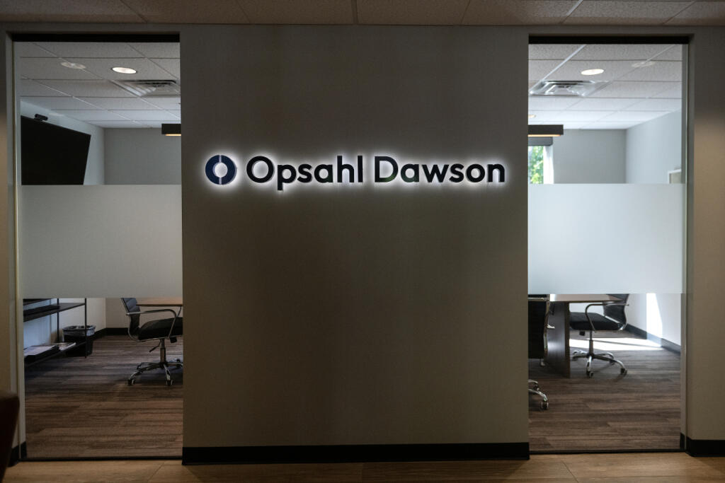 A sign is seen for Opsahl Dawson inside its Vancouver office June 22.