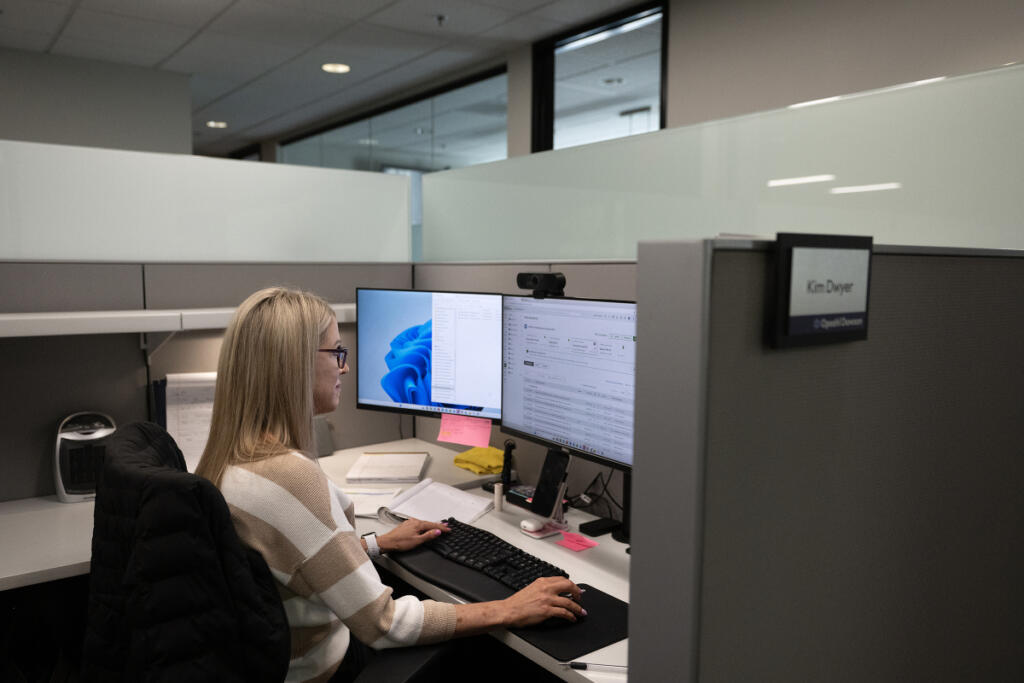 Kim Dwyer of Opsahl Dawson works at her desk in Vancouver on Monday morning. The local accounting firm continues to hear concerns from clients about Washington&rsquo;s changing tax code. (Amanda Cowan/The Columbian)