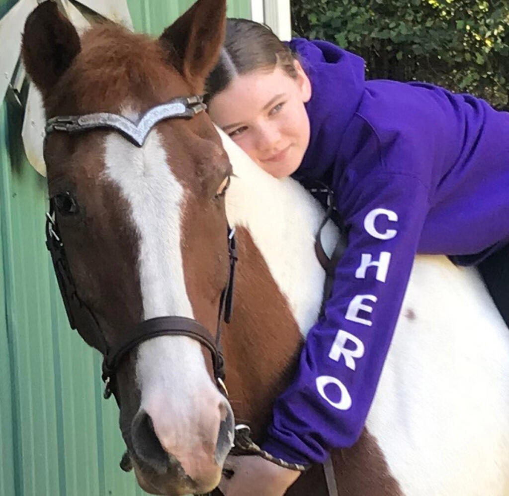 Cheyanne Greene poses with Cherokee, Son Rise Ranch&rsquo;s longtime mustang who died May 18 at 40, in an undated photo. (Contributed by Pam Cronkhite)