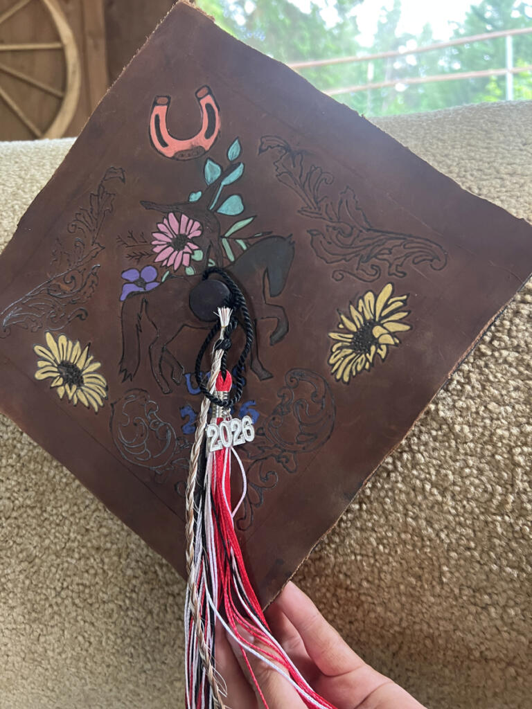 A braided section of Cherokee&rsquo;s tail is attached to the graduation cap of Son Ranch rider Ilura Anderson in advance of her June 5 graduation from Union High School. (Contributed by Pam Cronkhite)