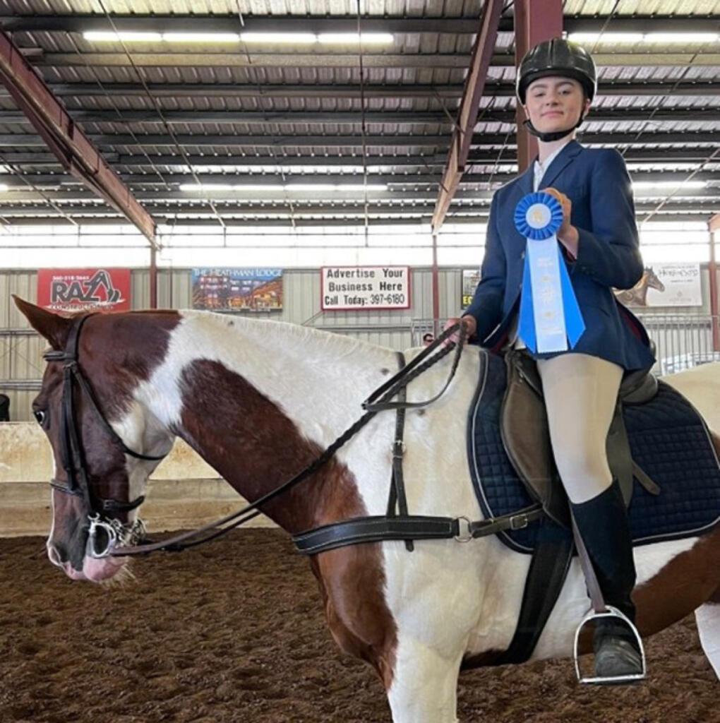 Lynnea Zevely poses with Cherokee, Son Rise Ranch&rsquo;s longtime mustang who died May 18 at 40, in an undated photo. (Contributed by Pam Cronkhite)