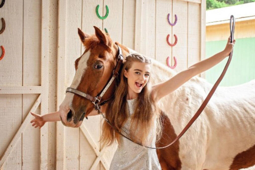 Lynnea Zevely poses with Cherokee, Son Rise Ranch&rsquo;s longtime mustang who died May 18 at 40, in an undated photo. (Contributed by Pam Cronkhite)